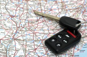 A set of car keys over a map symbolyzing travel