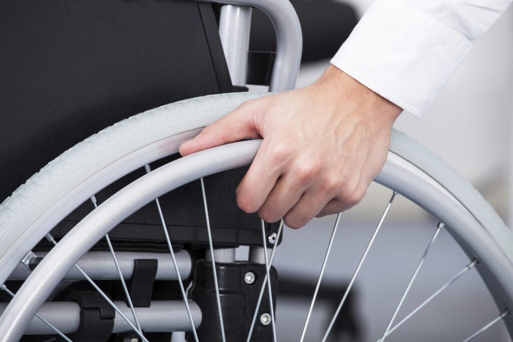 Close-up Of Businessman Sitting On Wheelchair In Office